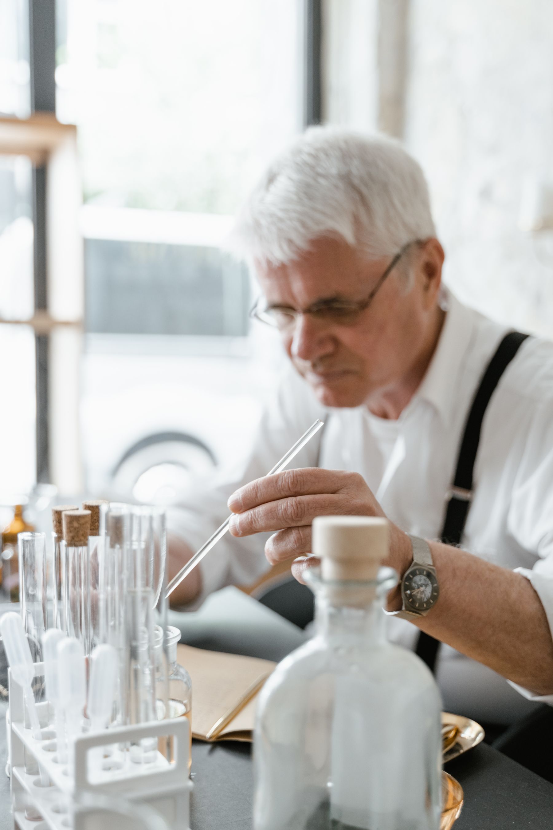 Senior researcher conducting a careful laboratory experiment